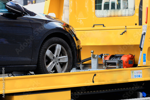 New car transported on yellow tow track. photo