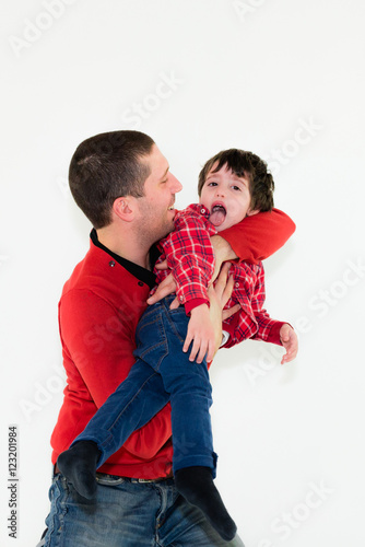 portrait of father and son playing together isolated on white background