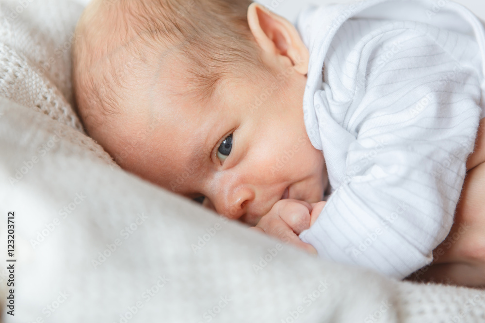 Newborn boy tries to taste his little hand Newborn boy tries to taste his little hand