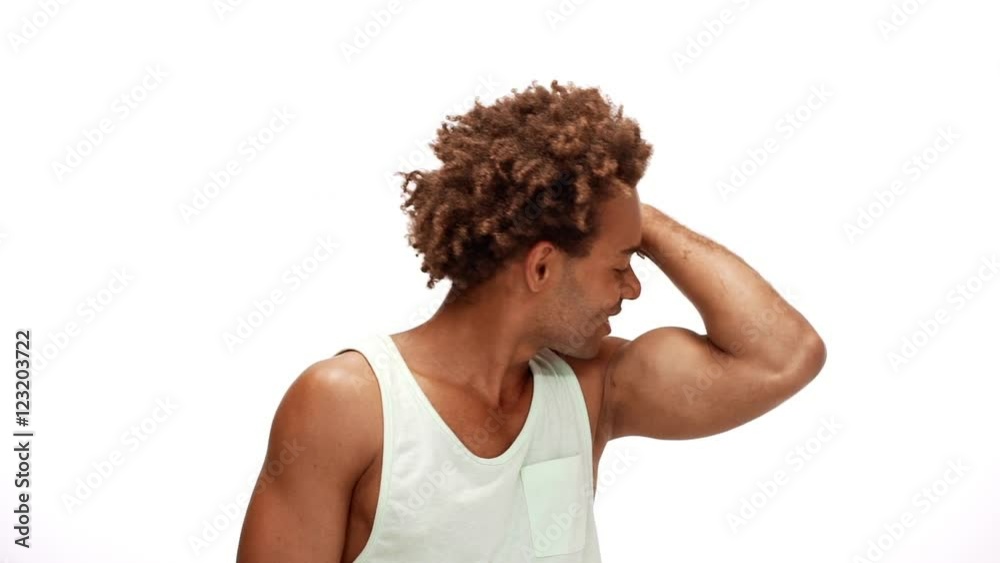 Man smiling showing muscles kissing biceps over white background Slow motion Man smiling showing muscles kissing biceps over white background Slow motion
