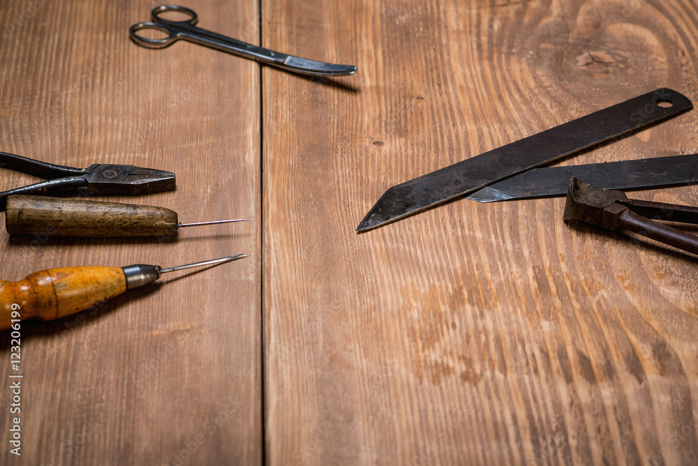 Set of tools for shoemaker on wooden background. Copy space. Set of tools for shoemaker on wooden background. Copy space.