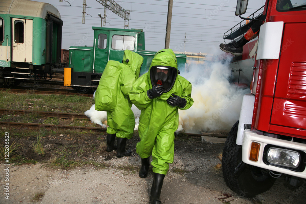 Fototapeta premium firemen in action, Firefighters exercises train accident, chemical contamination 
