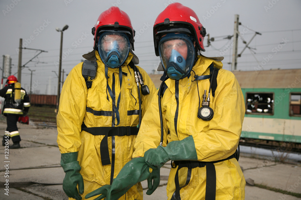 Obraz premium firemen in action, Firefighters exercises train accident, chemical contamination 