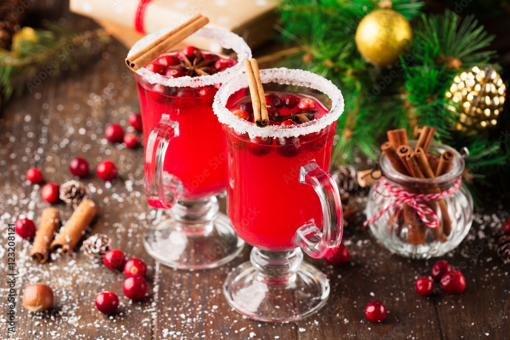 Festive Cranberry drink on Christmas background, rustic wooden table Festive Cranberry drink on Christmas background, rustic wooden table