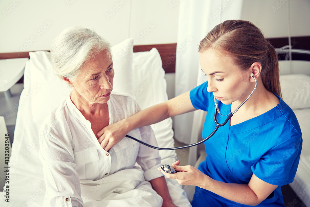 nurse with stethoscope and senior woman at clinic nurse with stethoscope and senior woman at clinic