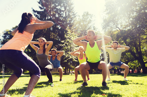 group of friends or sportsmen exercising outdoors photo