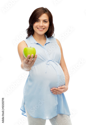 happy pregnant woman holding green apple