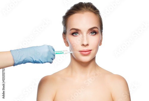 woman face and hand with syringe making injection