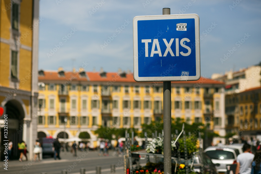 Blue street sign 'Taxis' stands on the Italian street