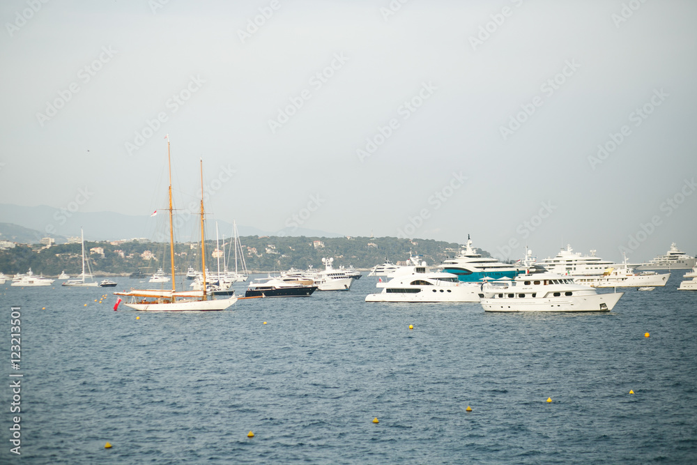 Look from the shore at beautiful white yachts floating in the se
