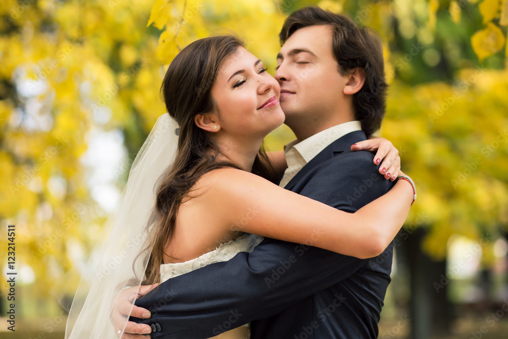 Young smiling bride and groom close portrait in summer park Young smiling bride and groom close portrait in summer park