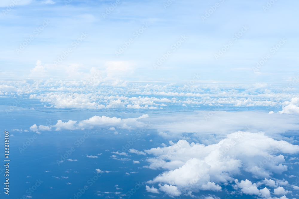 blue-sky-and-ocean-view-above-the-clouds-from-airplane-stock-photo