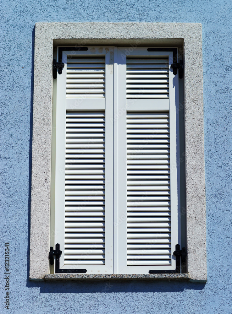 Window with shutters closeup view, sunny day on sea resort