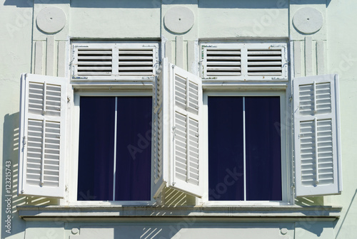 Window with shutters closeup view, sunny day on sea resort photo