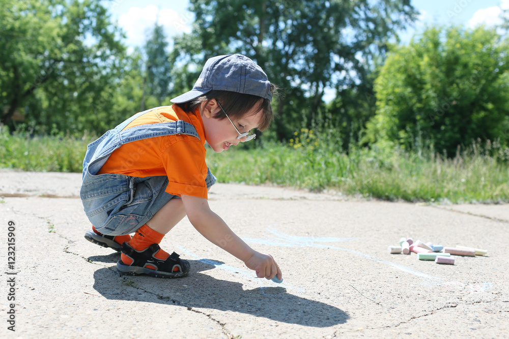 3 years boy draws with chalks in summertime 3 years boy draws with chalks in summertime