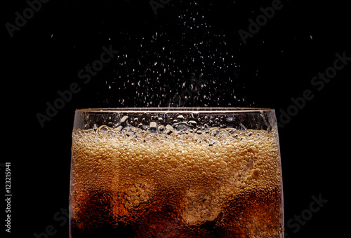 Ice cola with splashing CO bubbles.
