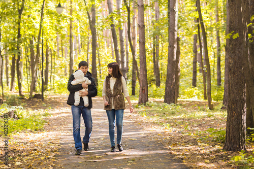 Young couple with newborn son outdoors in autumn © satura_