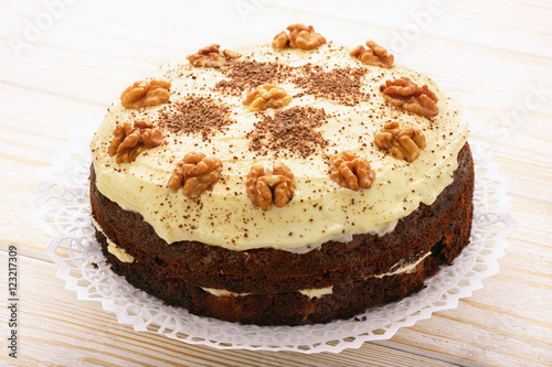 Carrot cake with cheese cream on white table.