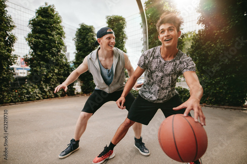 Happy teenagers playing basketball © Jacob Lund
