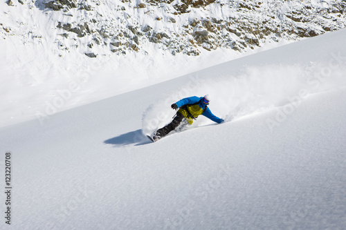 Male snowboarder snowboarding down steep mountain, Trient, Swiss Alps, Switzerland