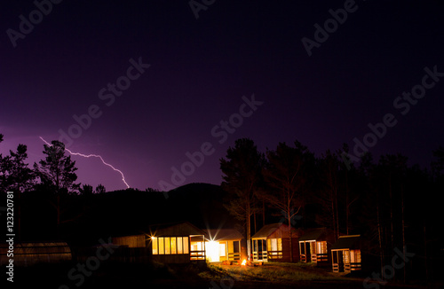 Lightning in the night sky over houses