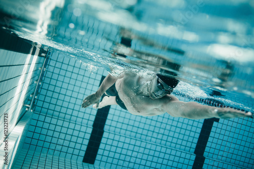 Fototapeta Naklejka Na Ścianę i Meble -  Professional male swimmer inside swimming pool
