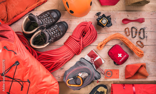 Overhead view of climbing equipment with climbing helmet, first aid kit, climbing boots and climbing ropes