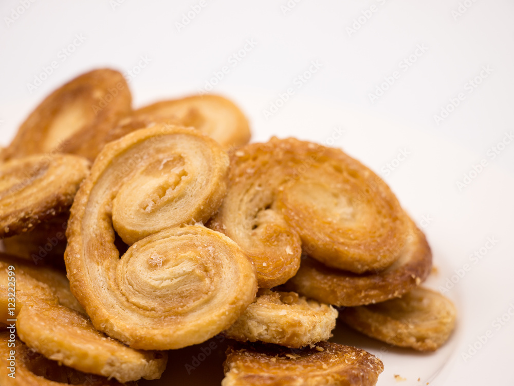 Golden and crisp palmier cookies. Pastry with sugar in a palm shape