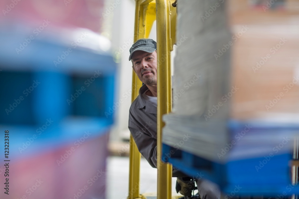 Forklift driver loading pallet onto truck at packaging factory Stock ...