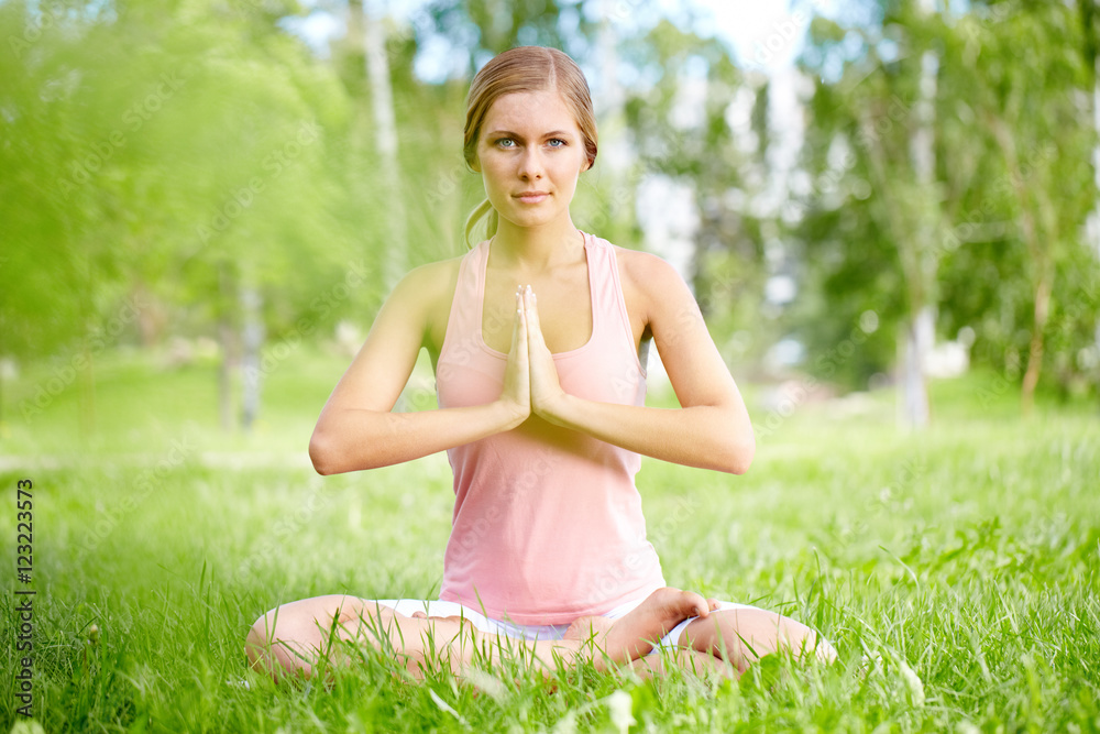 Portrait of a woman sitting in lotus position Portrait of a woman sitting in lotus position