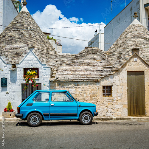 Vintage car in front of a Trulli house