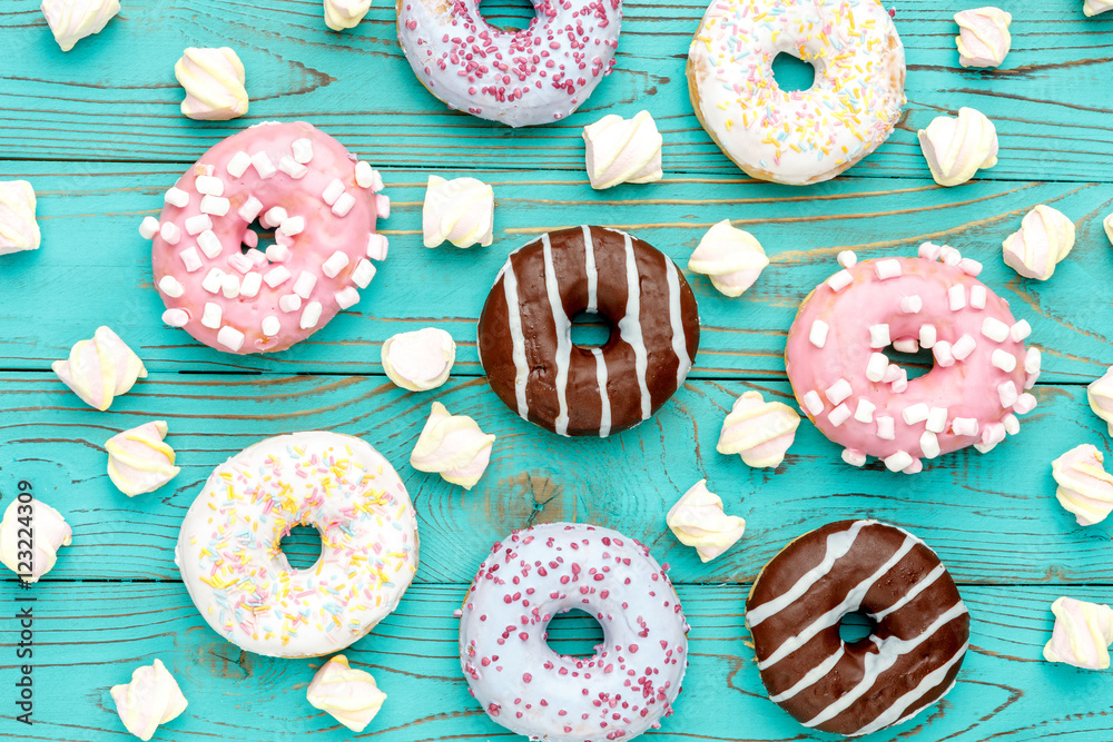 Donuts on colorful wooden background
