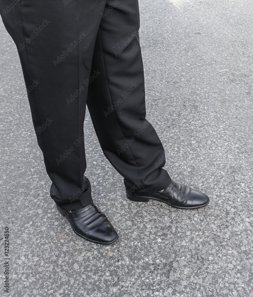 Male legs business black Shoe wear on the floor.