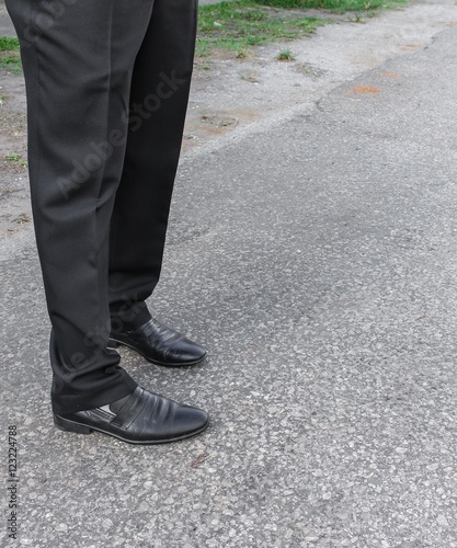 Male legs business black Shoe wear on the floor.