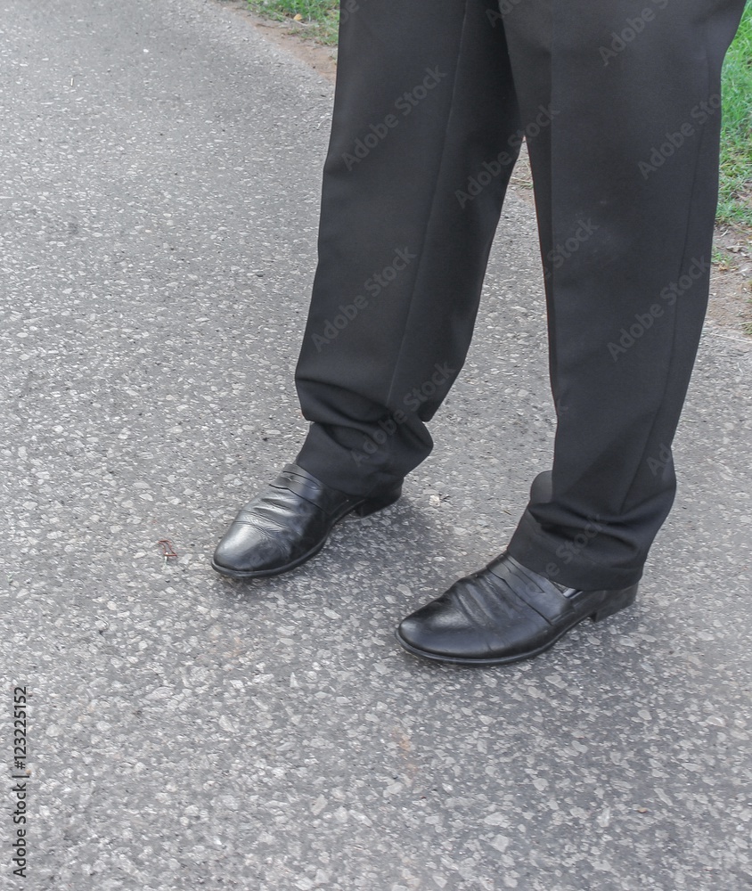 Male legs business black Shoe wear on the floor. Male legs business black Shoe wear on the floor.