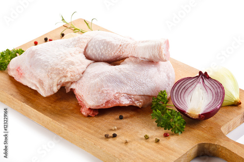 Raw chicken legs on cutting board 