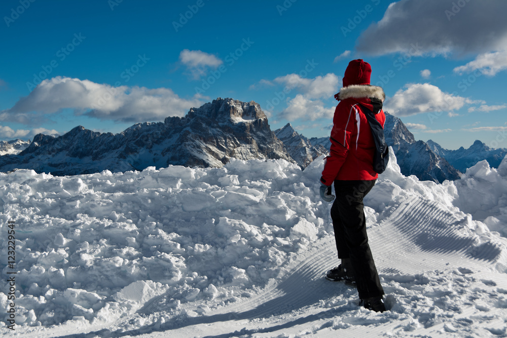 woman skier in a red ski equipment in the Alps , Cortina d'Ampezzo , Italy woman skier in a red ski equipment in the Alps , Cortina d'Ampezzo , Italy