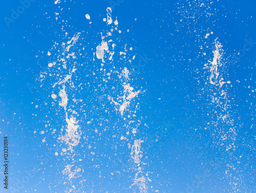 water splashing from the fountain in the background of blue sky