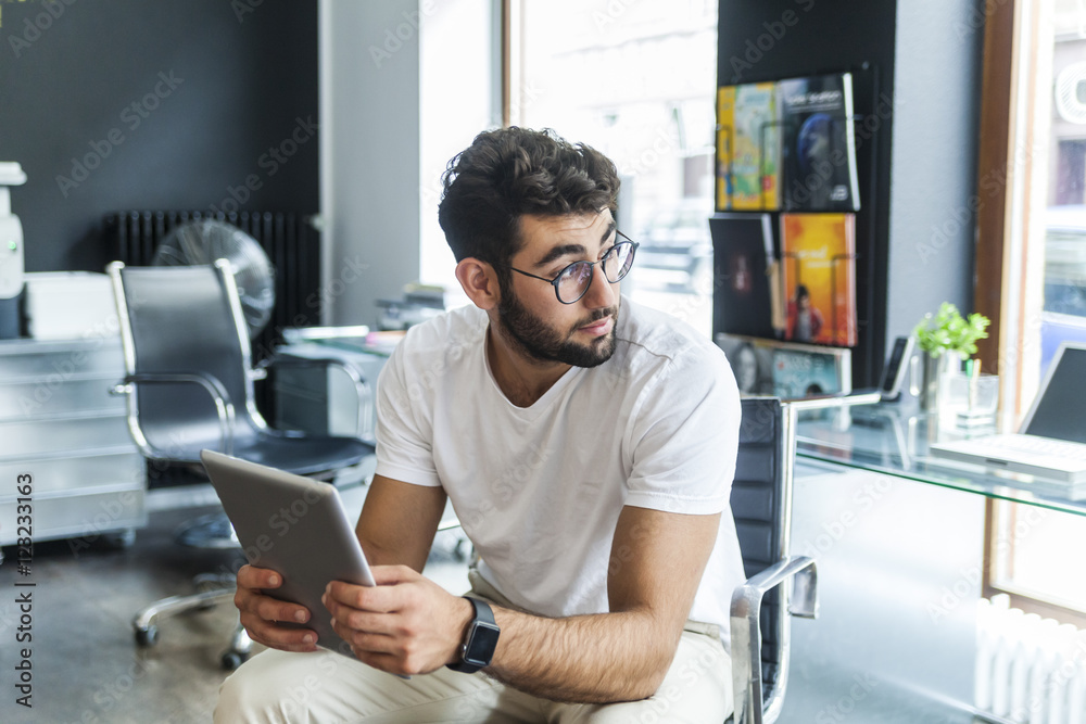 Young man with tablet in a modern office Young man with tablet in a modern office
