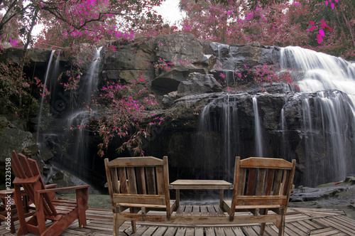 wooden chair in autumn forest at pang sida waterfall National Park sa kaeo Thailand