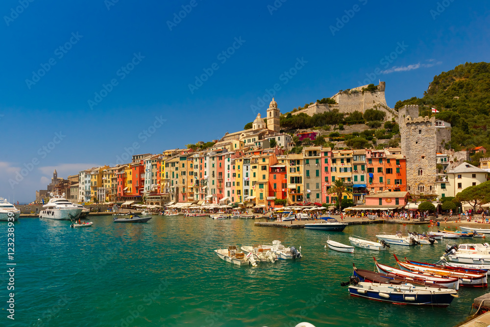 Colorful picturesque harbour of Porto Venere with San Lorenzo church, Doria Castle and Gothic Church of St. Peter, Italian Riviera, Liguria, Italy.