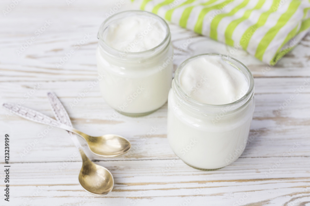 Homemade yogurt in glass jar on wooden table. Homemade yogurt in glass jar on wooden table.