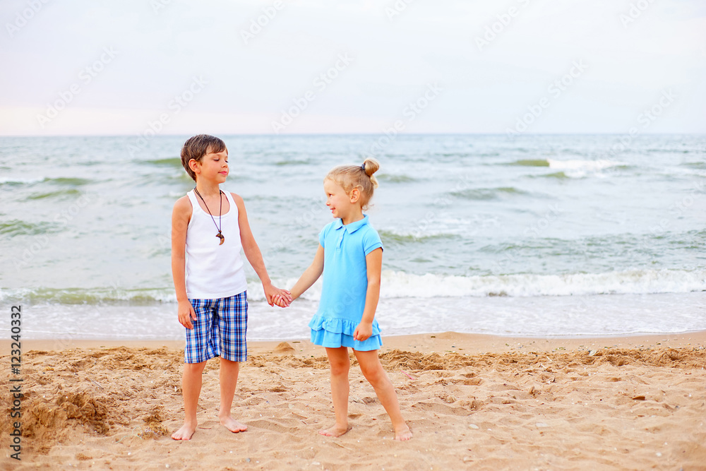 two children playing on beach two children playing on beach