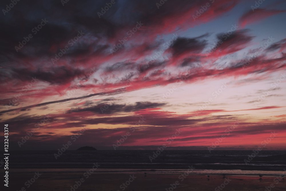 Colourful sunset over the beach at Polzeath Vintage Retro Filter