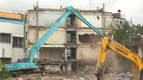 Excavator machinery working on demolition old building
