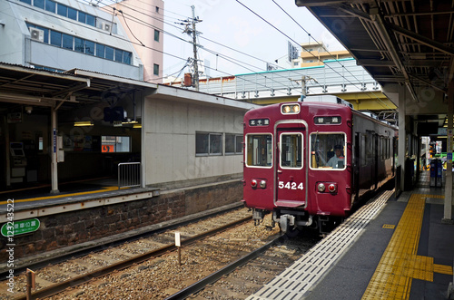 Red classic train of Hankyu kyoto line running from Kyoto statio photo