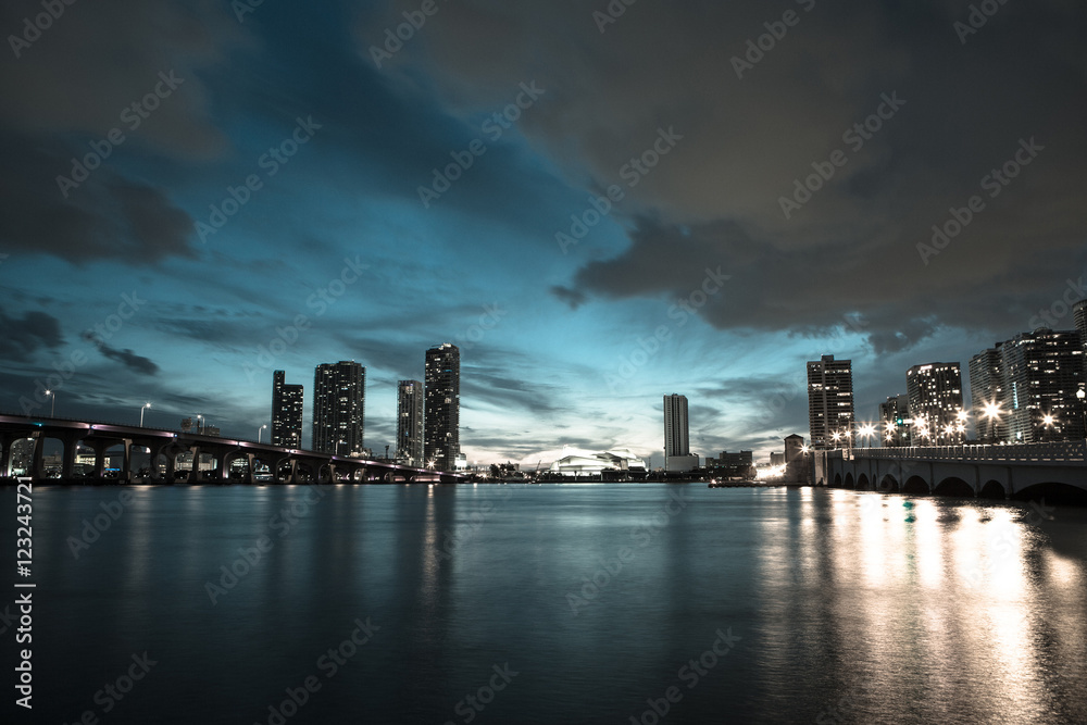 View on Miami Downtown and MacArthur Causeway at night time with a view on a bay, Sunset. USA