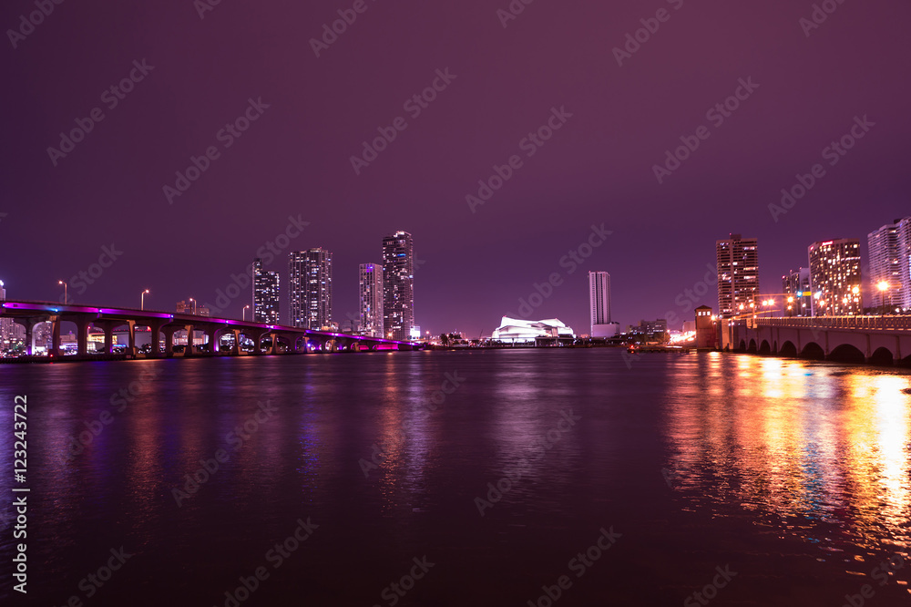 View on Miami Downtown and MacArthur Causeway at night time with a view on a bay, Sunset. USA