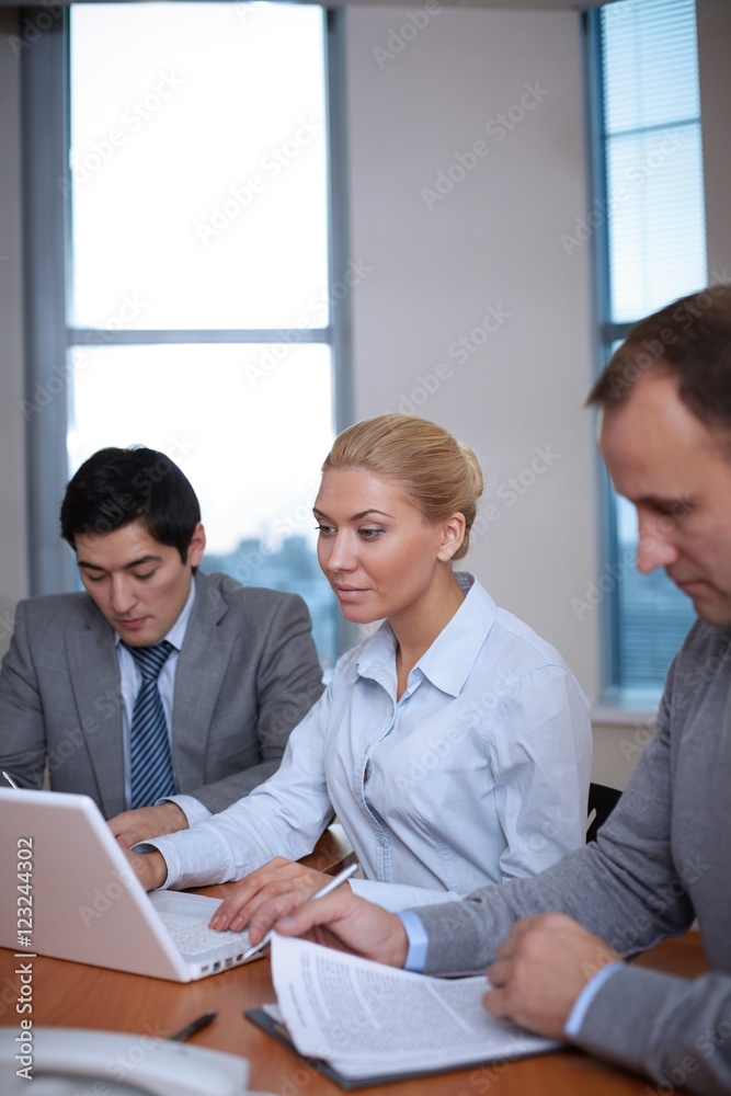 End of workday. Three business people working in office End of workday. Three business people working in office