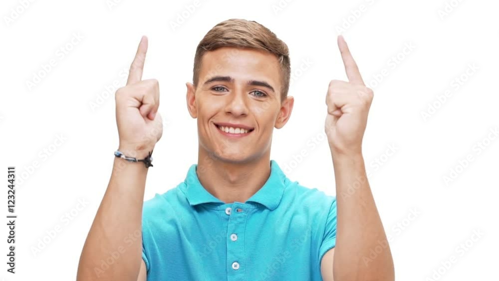 Young man pointing fingers at camera smiling over white background Slow motion Young man pointing fingers at camera smiling over white background Slow motion